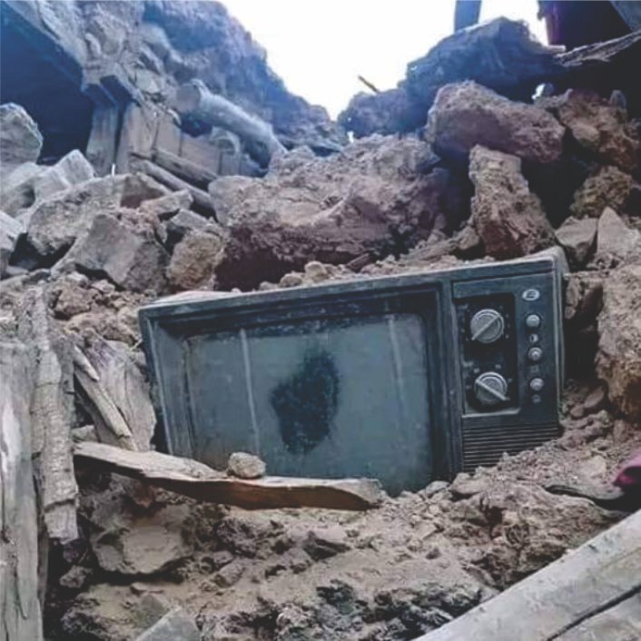 A television set sits on top of a pile of rubble in Morocco following deadly earthquake.