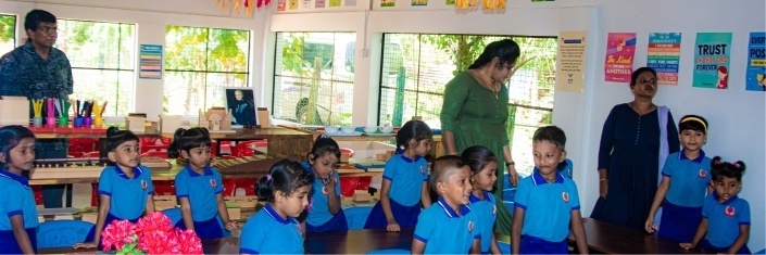 Group of Sri Lankan children in classroom with teachers
