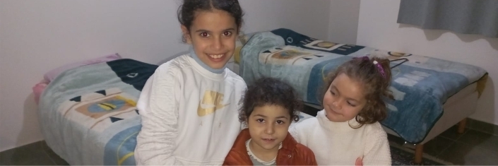 Three little girls smile at camera