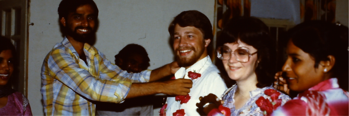 Man and woman being given gifts by two other individuals