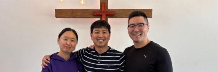 Three people smiling at camera