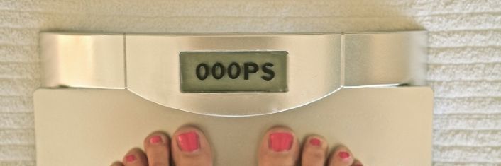 bathroom scale with "oops" instead of numbers