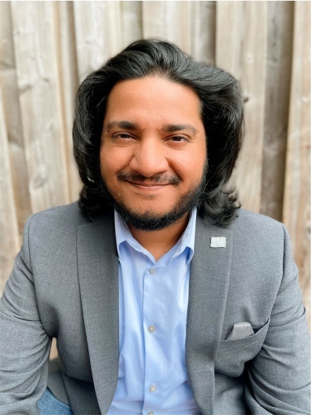 Smiling East Indian man wearing grey suit