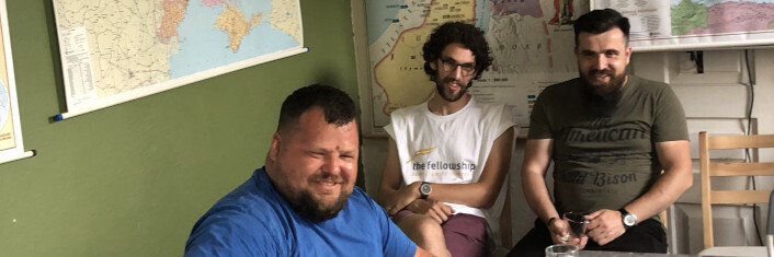 Three Polish men sitting in a room smiling
