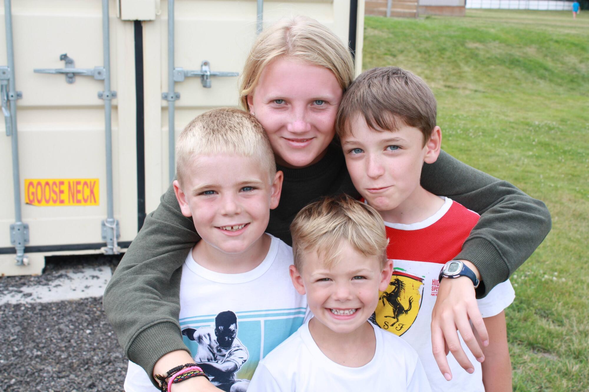 Four kids smiling for a picture