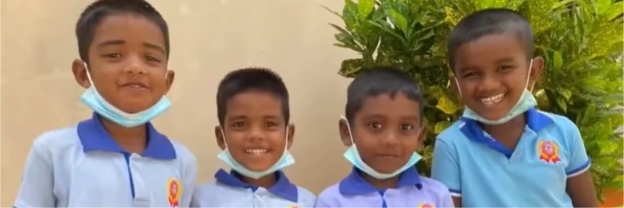 Group of young Sri Lankan boys smiling at camera