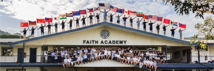 100 school students posing in front of school students some holding country flags